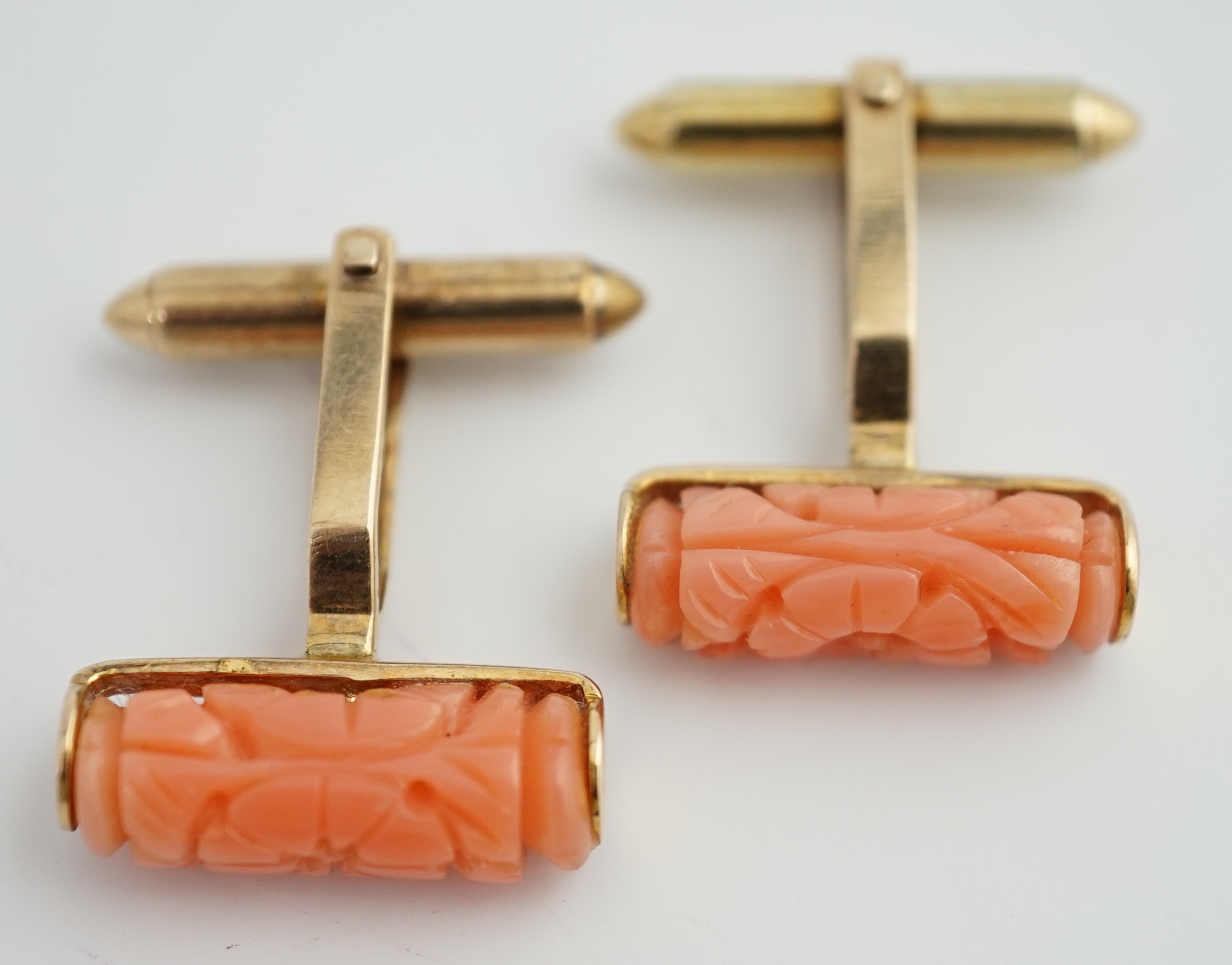 A pair of 9k gold and carved coral set cufflinks
